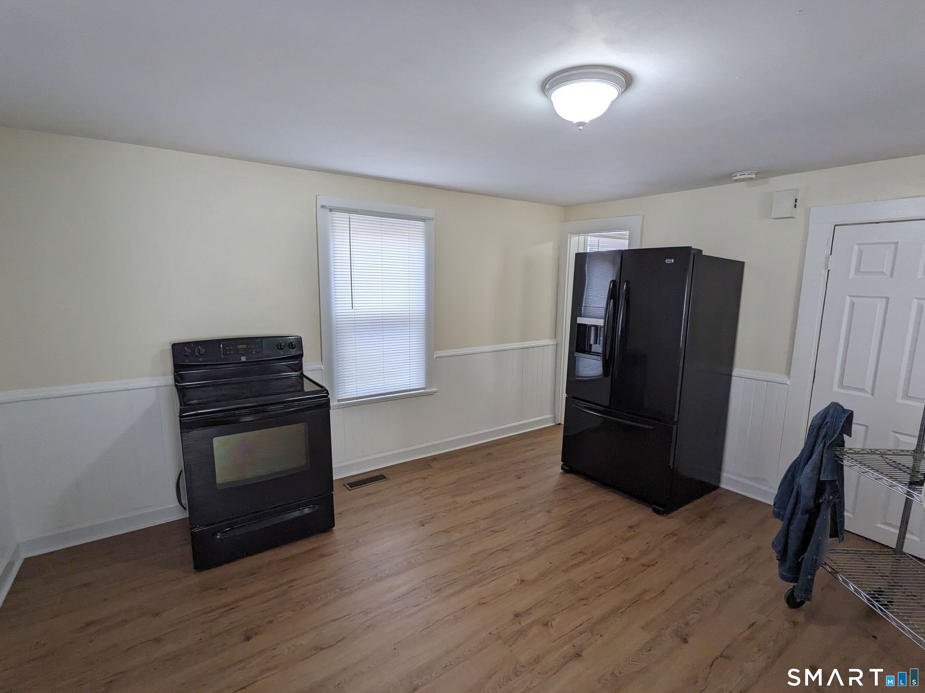 232 Hawkins Street Derby, CT 06418 - Photo 19 of 27 a kitchen with a refrigerator and a stove top oven