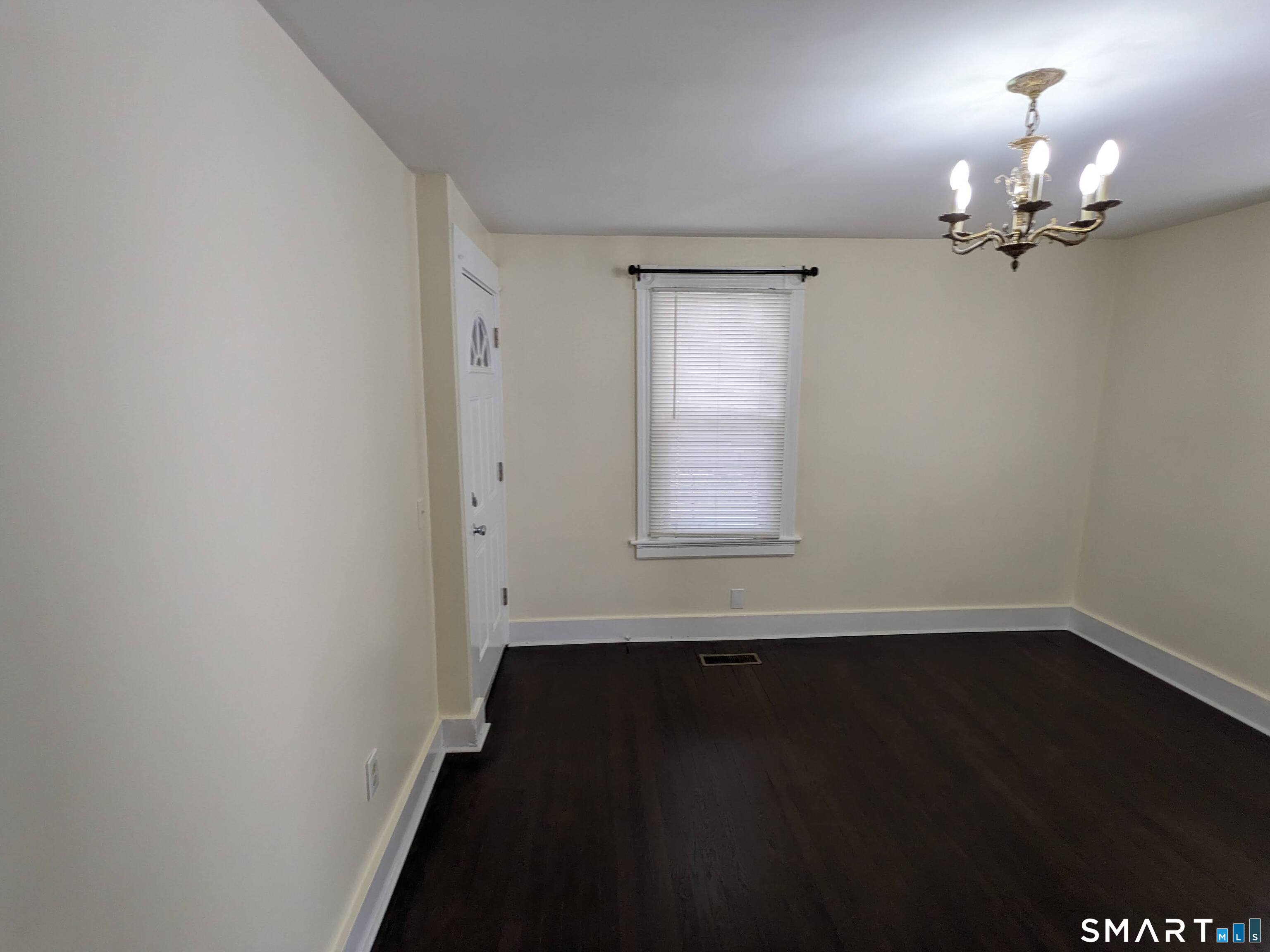 232 Hawkins Street Derby, CT 06418 - Photo 23 of 27 wooden floor in an empty room with a window