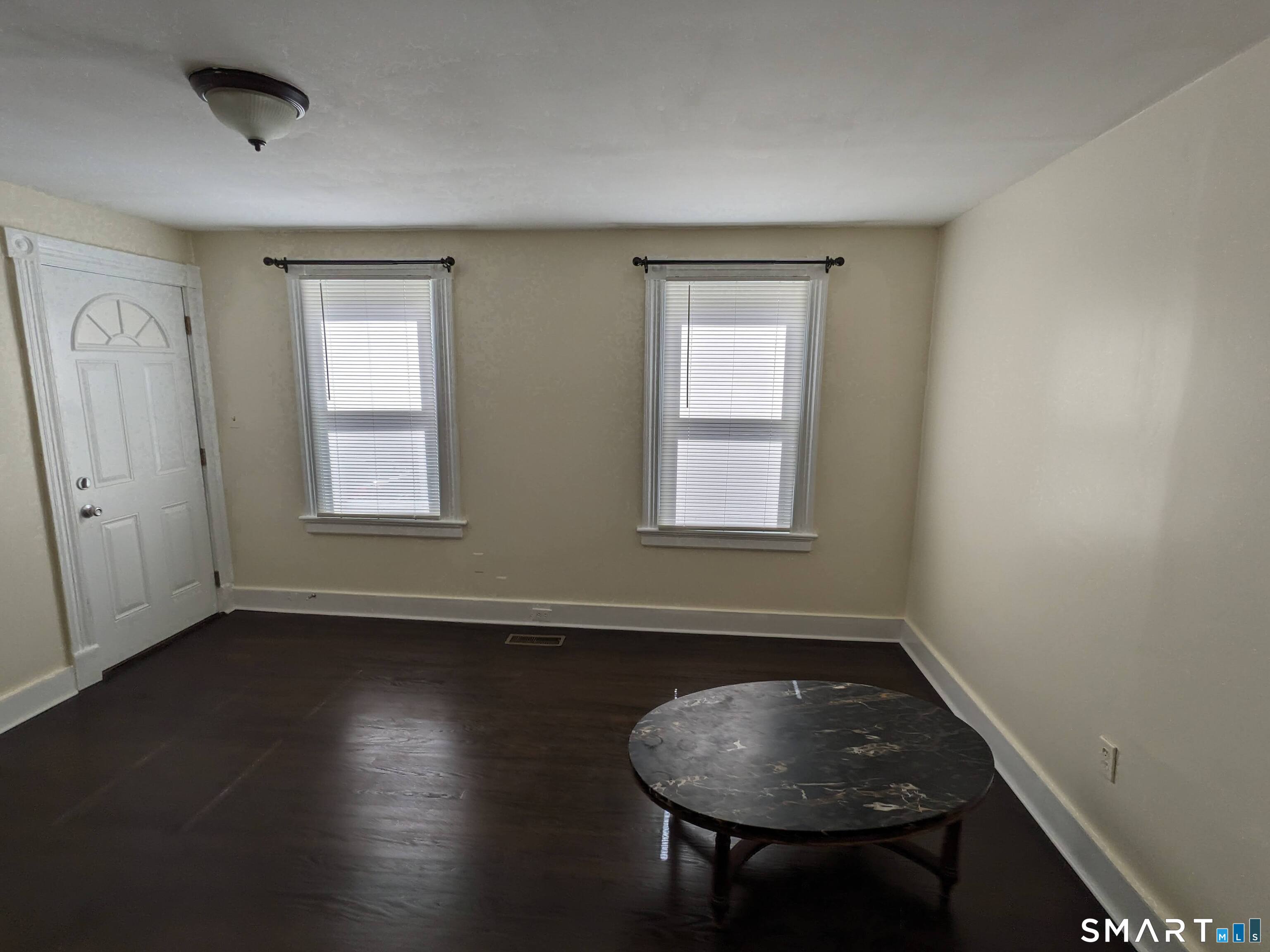 232 Hawkins Street Derby, CT 06418 - Photo 27 of 27 an empty room with wooden floor and windows