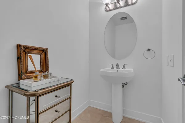 a bathroom with a sink a mirror and vanity