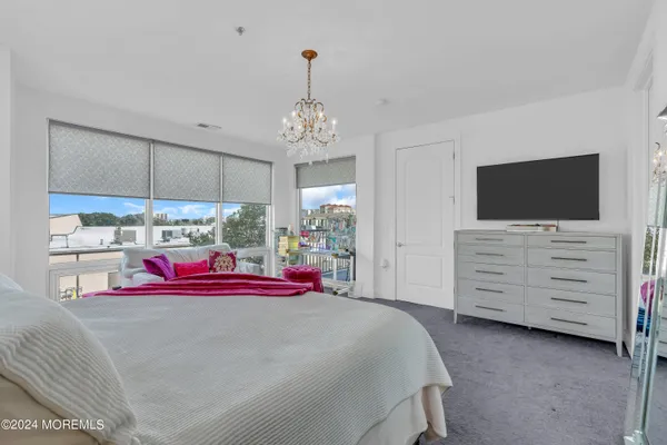 a bedroom with a bed and a flat tv screen