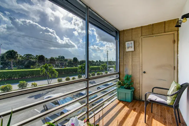 a view of a chair and tables in the balcony