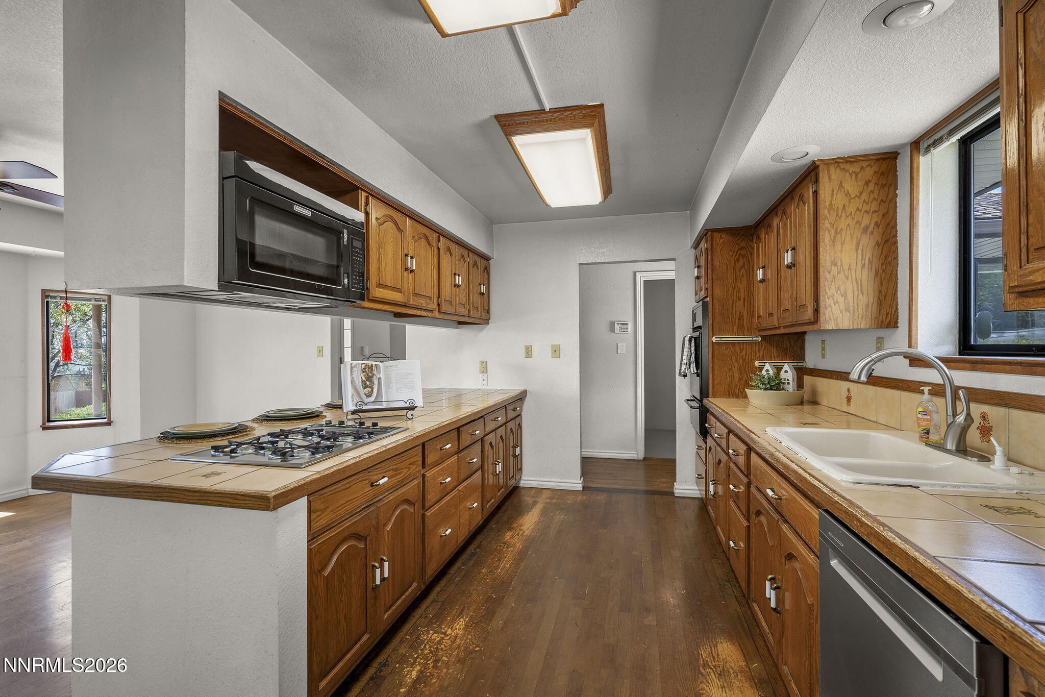 2985 Socrates Drive Reno, NV 89512 - Photo 42 of 52 a kitchen with stainless steel appliances granite countertop a sink stove and cabinets