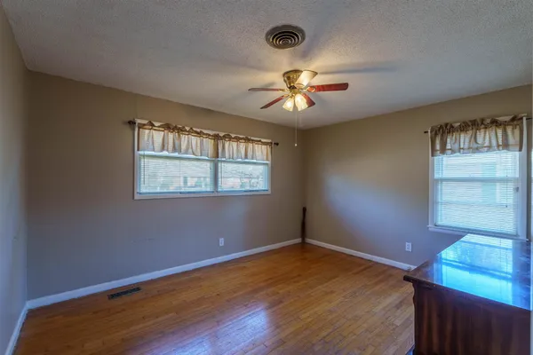 a view of room with a ceiling fan