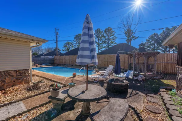 a backyard of a house with table and chairs