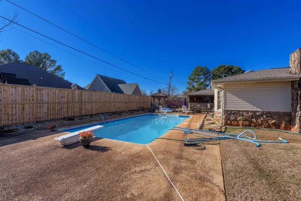 a backyard of a house with shaded area
