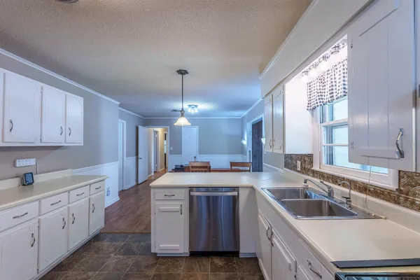 a kitchen with a sink stove and cabinets