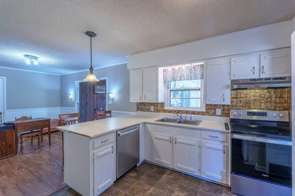 a kitchen with a sink stove and cabinets