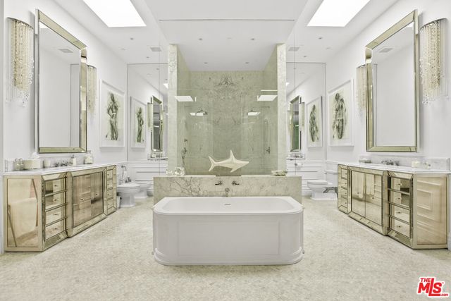 a living room with a bed furniture and a flat screen tv