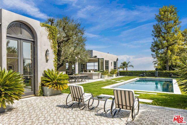 a view of a workspace with furniture and a potted plant