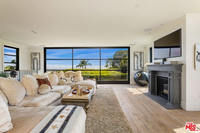 a living room with furniture a fireplace and a table