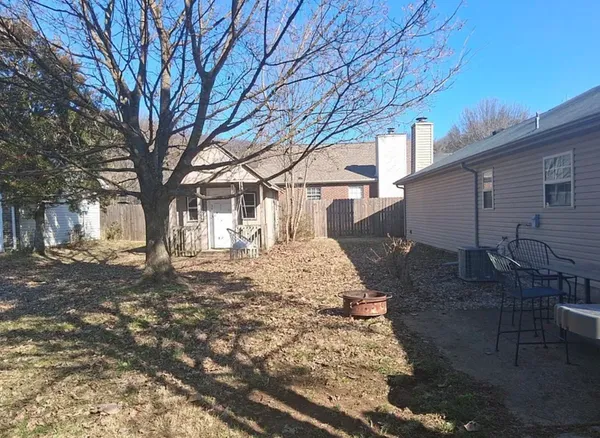 a view of a yard with a large tree
