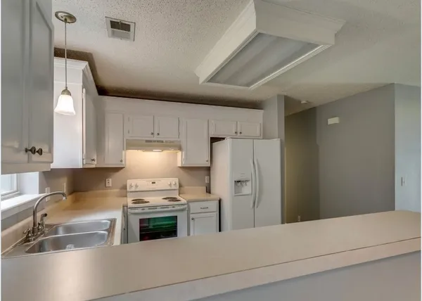 a kitchen with stainless steel appliances a refrigerator and a stove