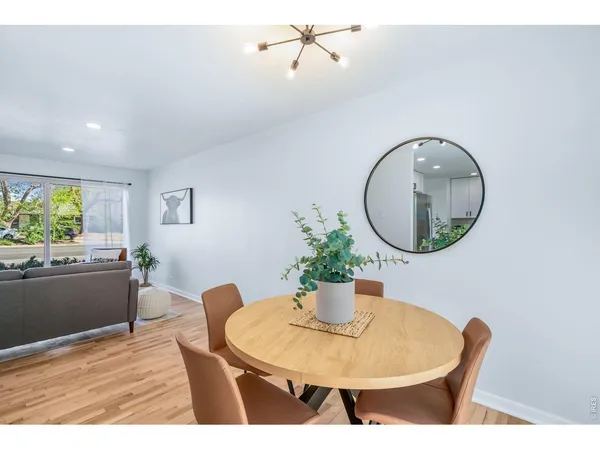 a living room with a table and chairs