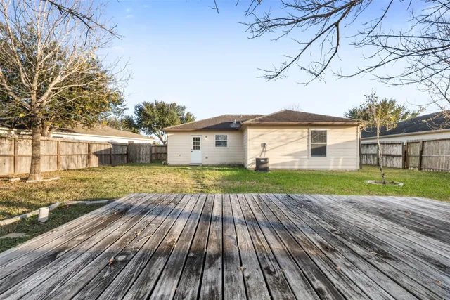 a view of house with backyard and wooden floor