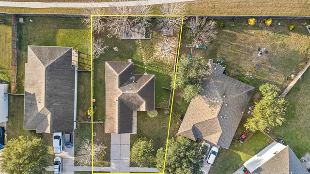 an aerial view of residential houses with outdoor space