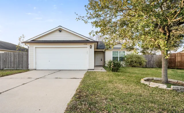 a view of a house with a yard and garage