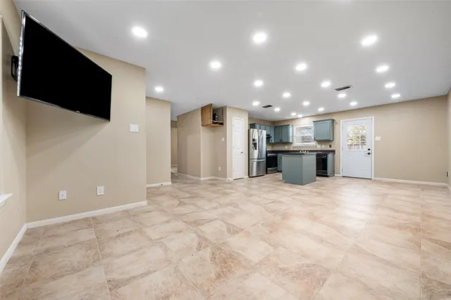 a view of kitchen with a sink and a refrigerator