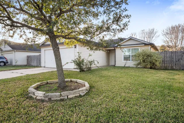 a front view of house with a garden