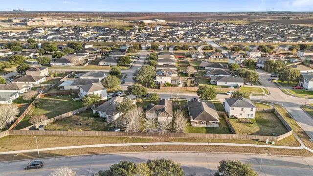 an aerial view of residential houses with outdoor space