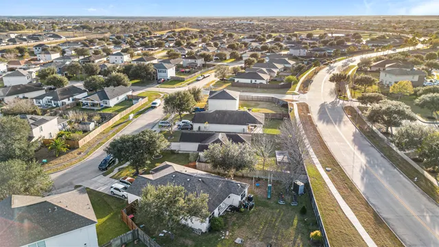an aerial view of a house with a yard basket ball court and outdoor seating