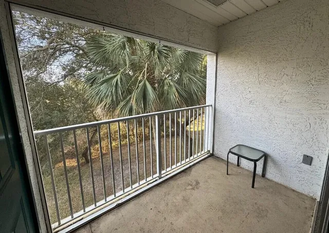a view of a balcony with wooden fence and floor