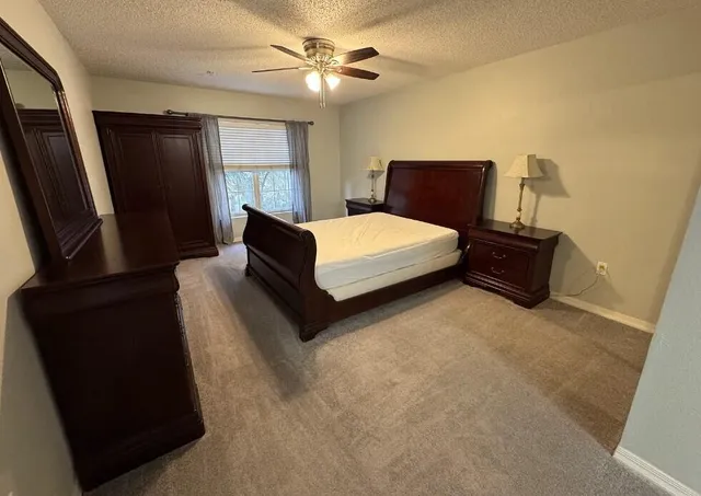 a bedroom with a bed and window