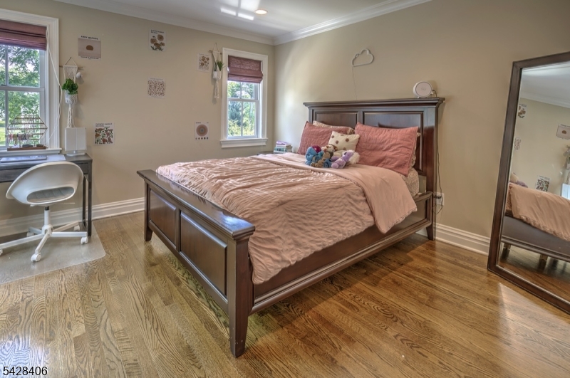 40 Sunnybrook Road Bernards, NJ 07920 - Photo 20 of 30 a bed sitting in a bedroom next to a window with chair and a large window