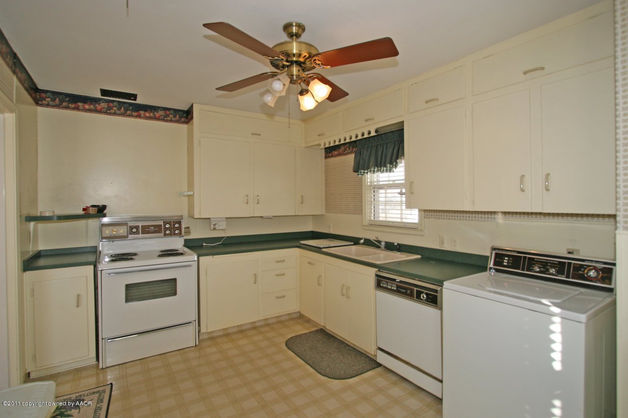 927 South Rusk Street Amarillo, TX 79102 - Photo 5 of 13 a kitchen that has a sink cabinets and window