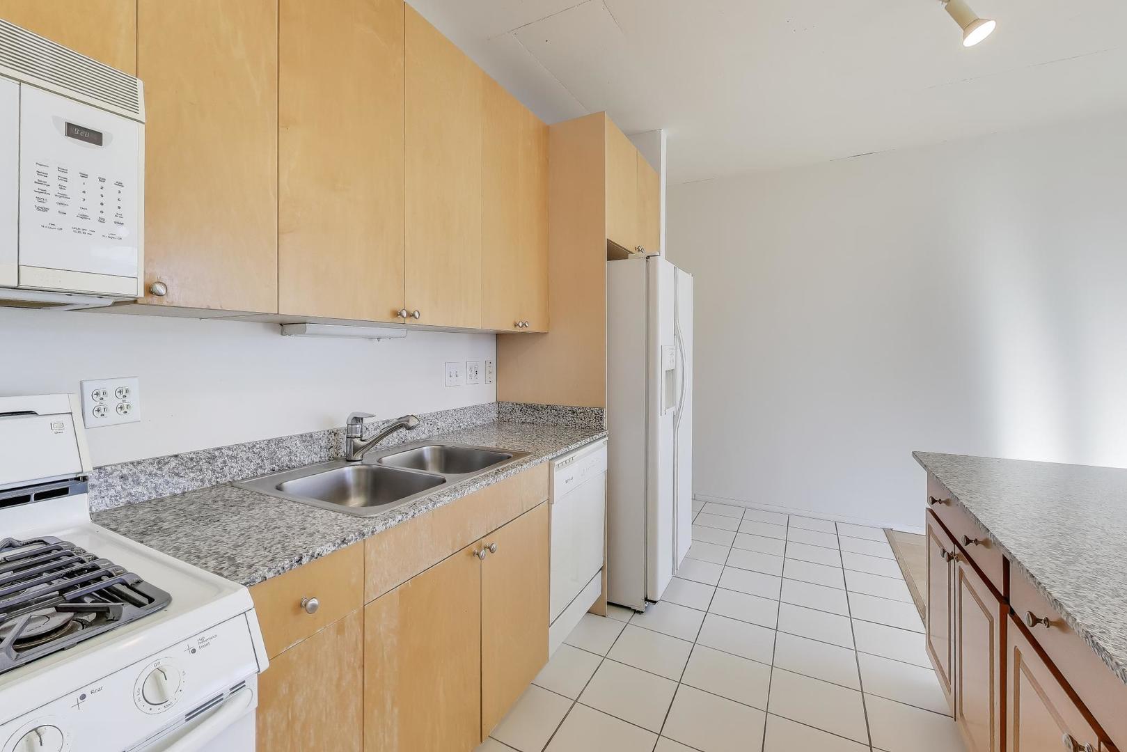 701 South Wells Street, Unit 1402 Chicago, IL 60607 - Photo 12 of 47 a kitchen with a sink a stove and cabinets