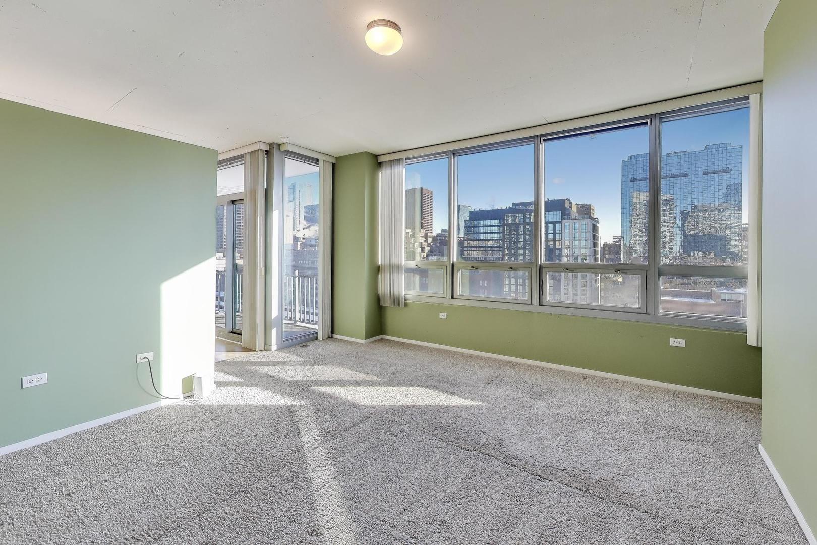701 South Wells Street, Unit 1402 Chicago, IL 60607 - Photo 15 of 47 a view of an empty room with a fireplace and a ceiling fan