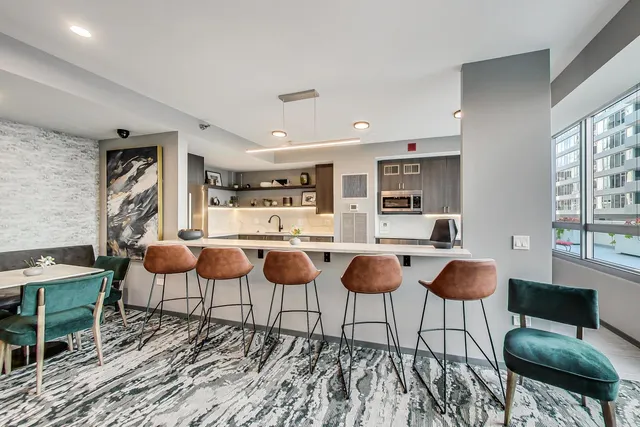 a living room with chairs and a table