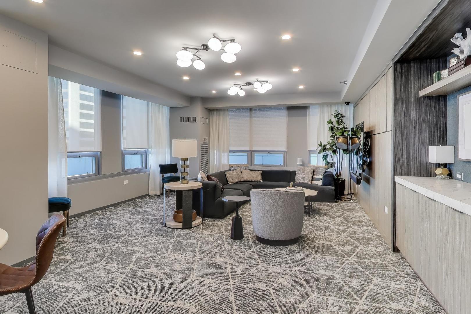701 South Wells Street, Unit 1402 Chicago, IL 60607 - Photo 30 of 47 a living room with furniture and a chandelier
