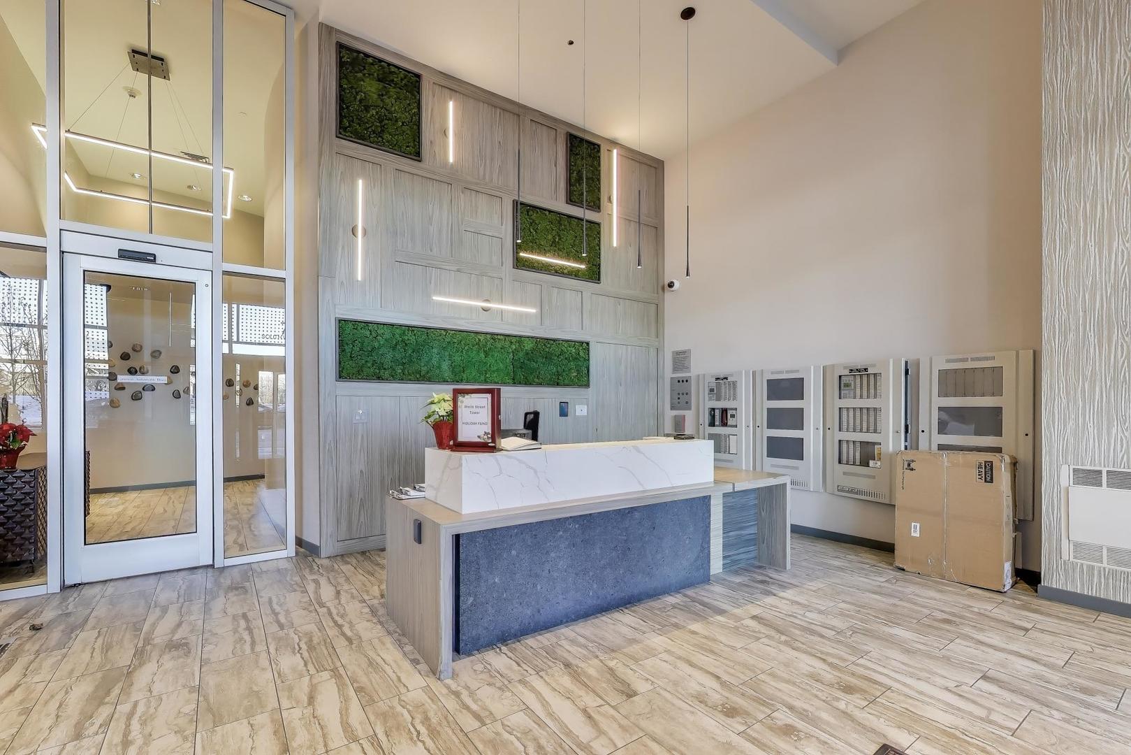 701 South Wells Street, Unit 1402 Chicago, IL 60607 - Photo 6 of 47 a large room with stainless steel appliances kitchen island granite countertop a refrigerator and a stove