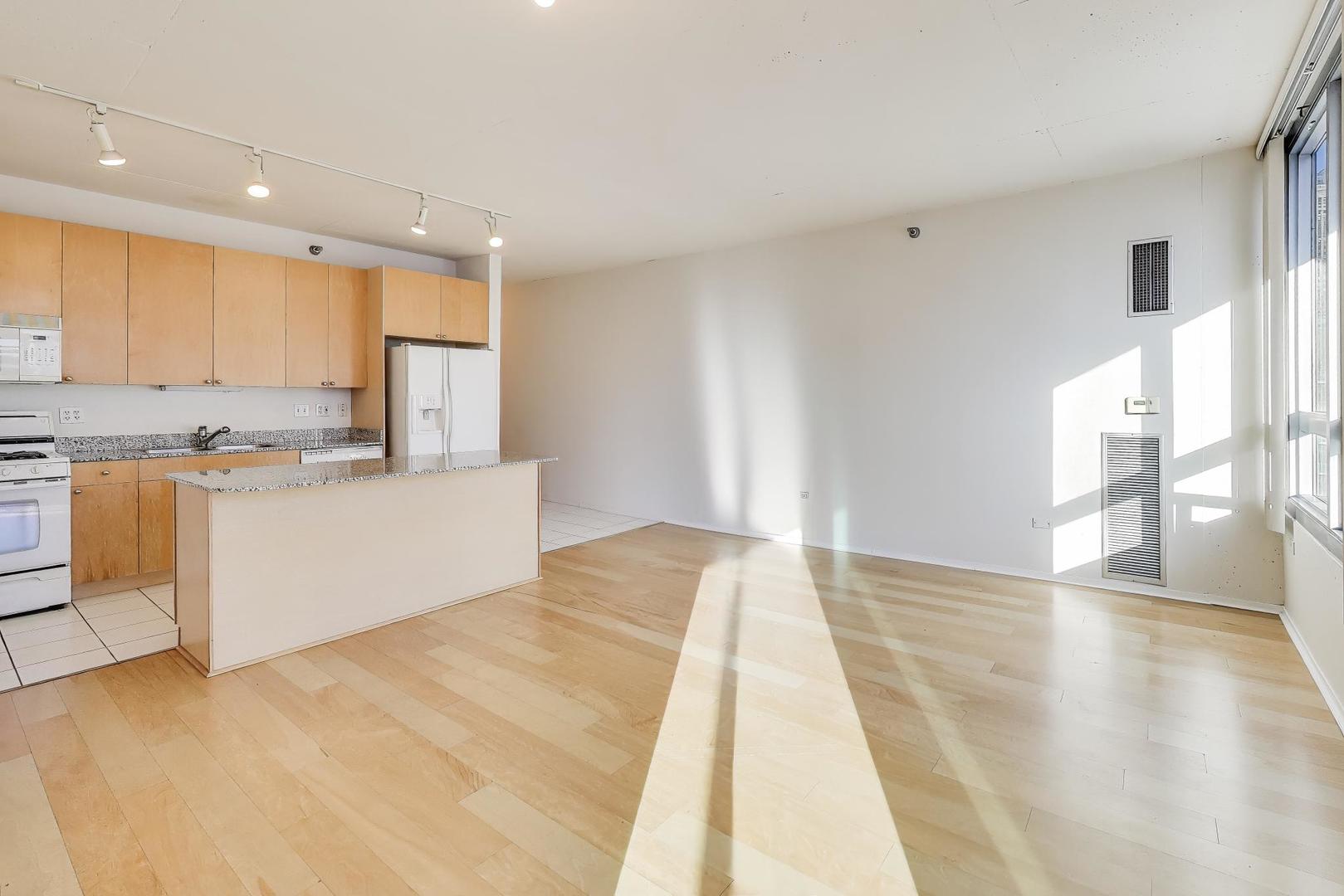 701 South Wells Street, Unit 1402 Chicago, IL 60607 - Photo 10 of 47 a view of empty room with wooden floor and window