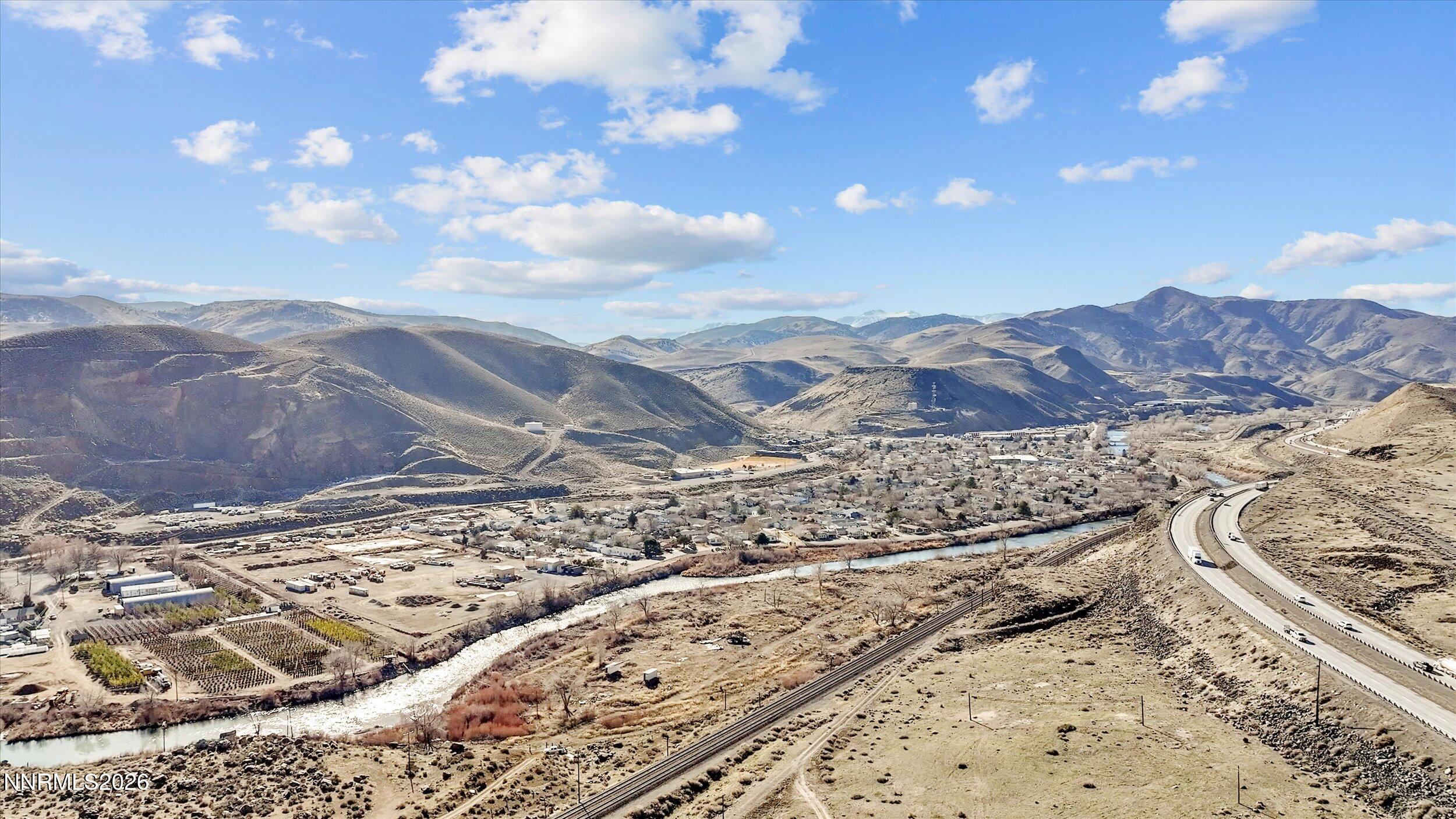 12615 Mustang Road Sparks, NV 89434 - Photo 6 of 10 a view of a dry yard with mountains in the background