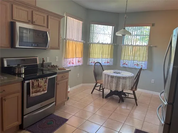 a dining room with furniture a window and a kitchen view