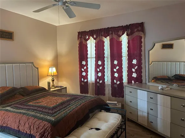 a bedroom with a large bed and a chandelier