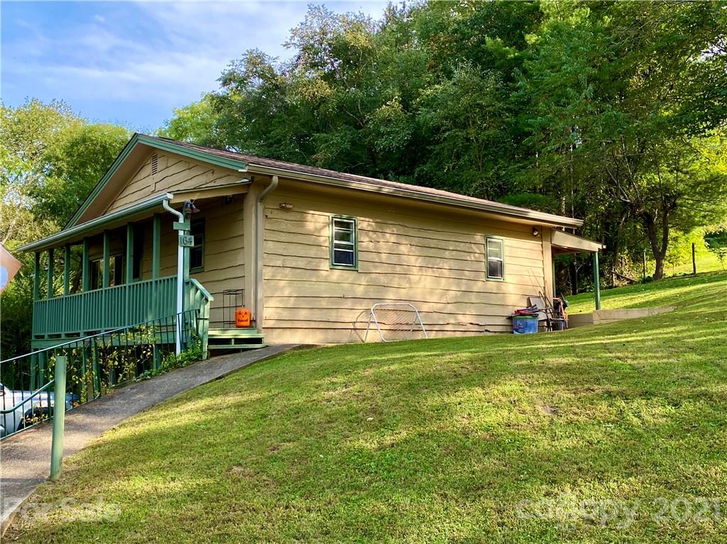 162 Upper Brush Creek Road Fletcher, NC 28732 - Photo 2 of 9 a front view of a house with a garden