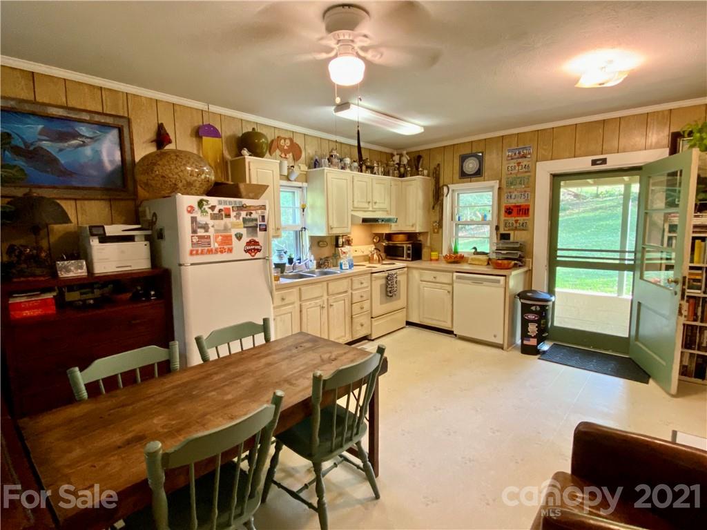 162 Upper Brush Creek Road Fletcher, NC 28732 - Photo 9 of 9 a kitchen with sink a refrigerator and chairs