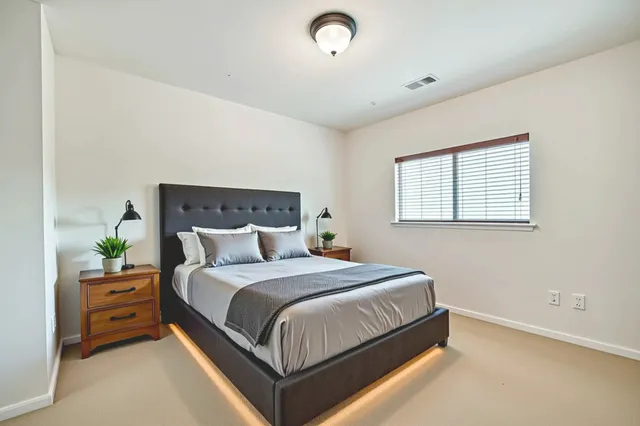 a bedroom with a bed and a night stand