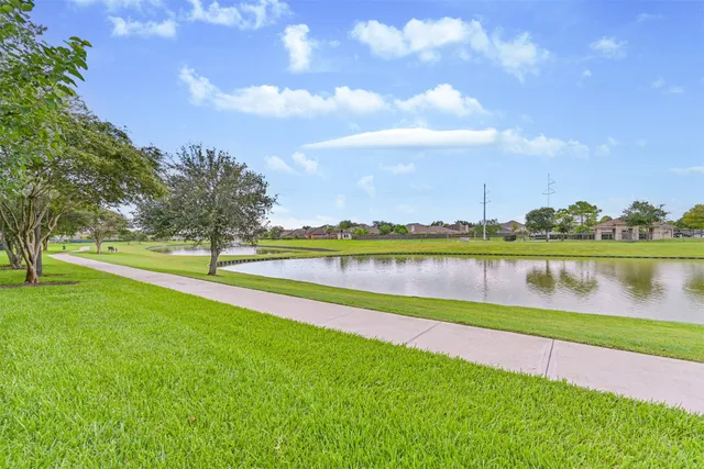 a view of a lake with houses in the background