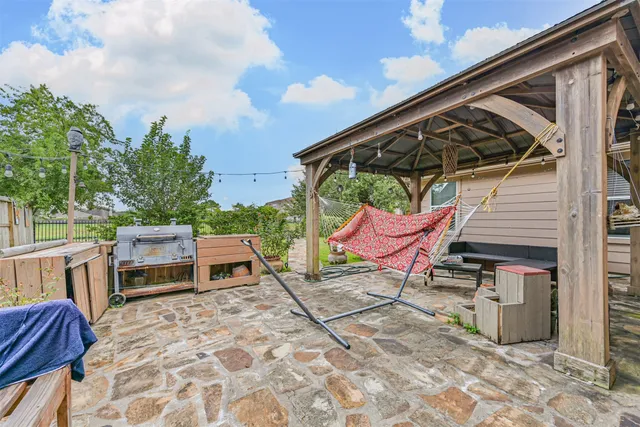 a roof deck with table and chairs a barbeque