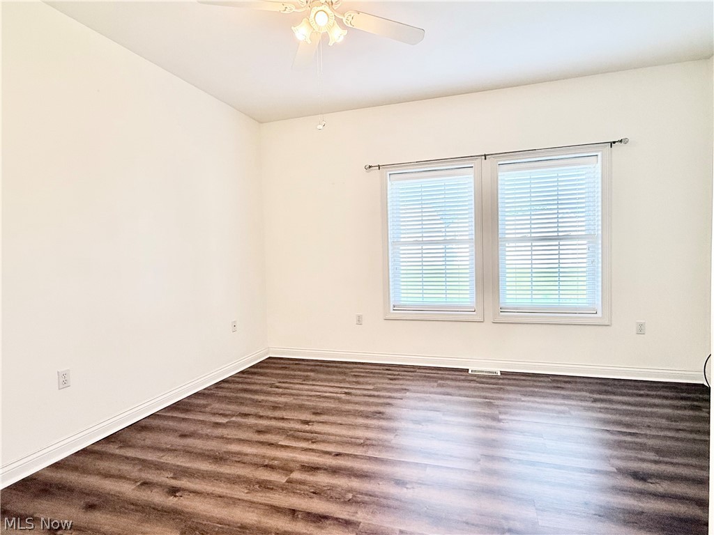 603 South Raccoon Road, Unit 1 Austintown, OH 44515 - Photo 11 of 22 Spacious room featuring wood-finish flooring, white baseboards, and neutral wall paint