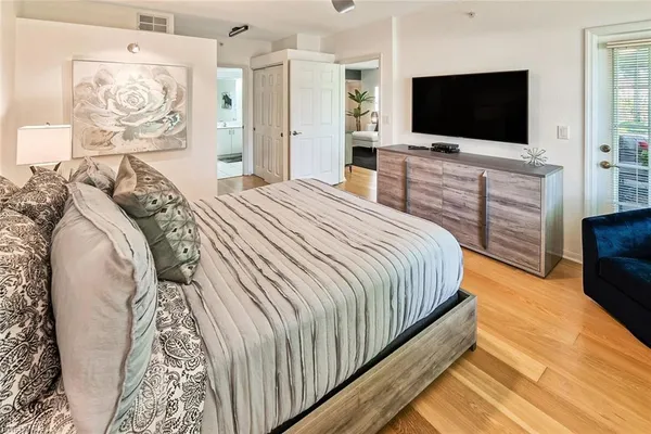 a bedroom with a bed and a flat screen tv