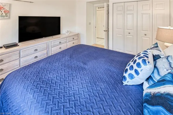 a bedroom with a bed and flat screen tv