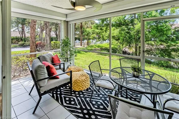 a view of a chairs and table in patio with a garden