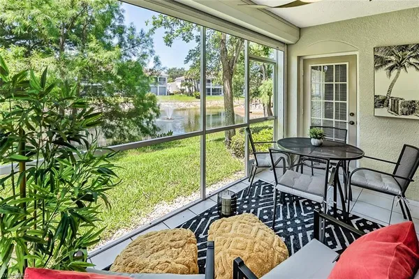 a balcony with table and chairs