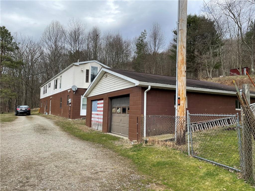 4 Lewis Road Shelocta, PA 15774 - Photo 17 of 18 a front view of a house with a yard and garage