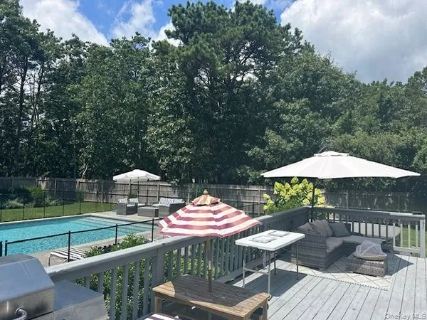 a backyard of a house with table and chairs